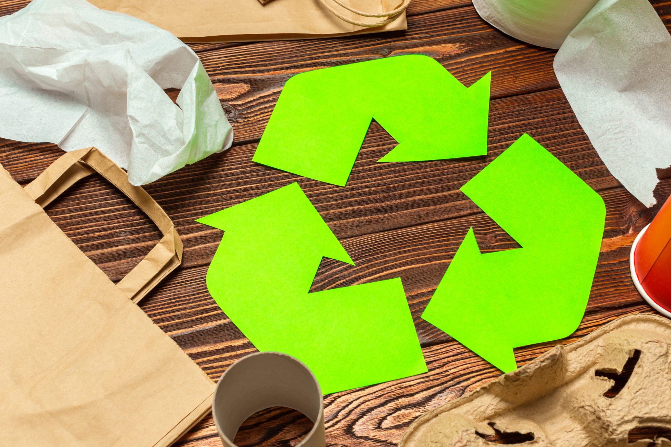 a green recycle symbol on a table