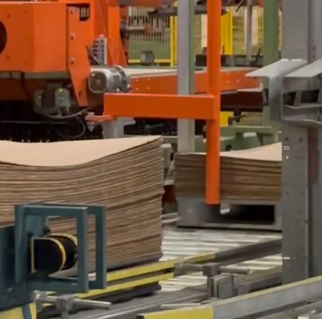 a large stack of cardboard in a factory